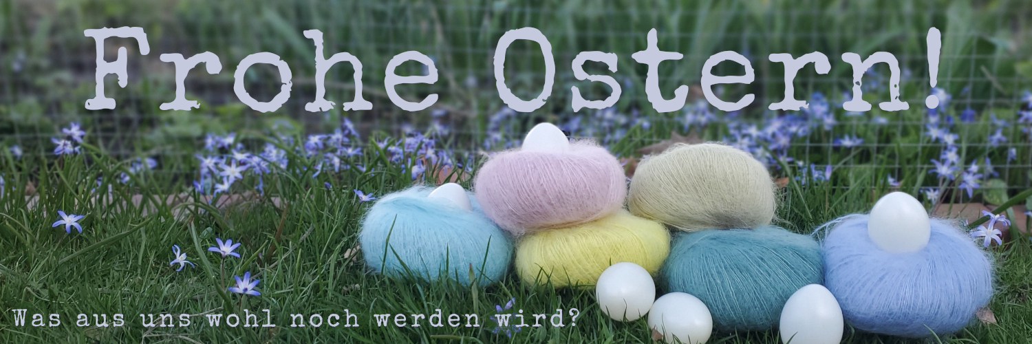 Sechs Mohairknäuel in verschiedenen Farben auf einer BlümchenwieseSchriftzug: Frohe Ostern! und Was wohl aus uns noch werden wird?